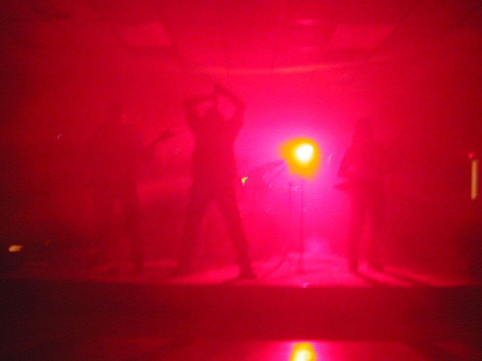 Dark Days in silhouette against stage light